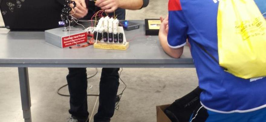 A table with two children's hands working on an electricity experiment.